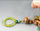 Clay and glass beads on beading wire forming a loop